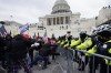 FILE - Violent insurrections loyal to President Donald Trump break through a police barrier at the Capitol in Washington. Over months, the House Select Committee investigating the Jan. 6 U.S. Capitol insurrection has issued more than 100 subpoenas, done more than 1,000 interviews and probed more than 100,000 documents to get to the bottom of the attack that day in 2021 by supporters of former President Donald Trump. (AP Photo/Julio Cortez, File)