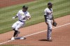 Pittsburgh Pirates' Yu Chang, left, takes third behind Detroit Tigers third baseman Harold Castro on a hit by Michael Perez in the third inning of a baseball game, Wednesday, June 8, 2022, in Pittsburgh. (AP Photo/Keith Srakocic)