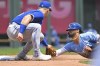 Kansas City Royals' Emmanuel Rivera, right, is caught stealing second base by Toronto Blue Jays third baseman Matt Chapman, left, during the fourth inning of a baseball game, Wednesday, June 8, 2022, in Kansas City, Mo. (AP Photo/Reed Hoffmann)
