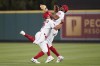 Los Angeles Angels second baseman Jack Mayfield (9) and right fielder Jo Adell (7) collide while reaching to catch a fly ball hit by Boston Red Sox's Xander Bogaerts during the seventh inning of a baseball game in Anaheim, Calif., Wednesday, June 8, 2022. Adell caught the ball. (AP Photo/Ashley Landis)