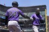 Colorado Rockies' Charlie Blackmon, right, is congratulated by Ryan McMahon after scoring against the San Francisco Giants during the fourth inning of a baseball game in San Francisco, Thursday, June 9, 2022. (AP Photo/Jeff Chiu)