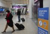 People travel at Pearson International Airport during the COVID-19 pandemic in Toronto, on Dec. 3, 2021. THE CANADIAN PRESS/Nathan Denette