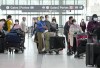 People wait in line to check in at Pearson International Airport in Toronto on Thursday, May 12, 2022. THE CANADIAN PRESS/Nathan Denette