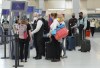 People wait in line to check in at Pearson International Airport in Toronto on Thursday, May 12, 2022. Sources confirm the federal government is putting an end to COVID-19 vaccine mandates for domestic and outbound international travellers and public sector workers. THE CANADIAN PRESS/Nathan Denette