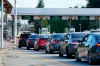 A line of vehicles wait to enter Canada at the Peace Arch border crossing Monday, Aug. 9, 2021, in Blaine, Wash. Border-city mayors, tourism industry leaders and an opposition MP say it’s time to bid a less-than-fond farewell to the ArriveCan app. (AP Photo/Elaine Thompson)