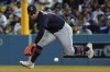 CORRECTS THAT BELLINGER REACHED ON AN ERROR, NOT A SINGLE - Cleveland Guardians second baseman Andres Gimenez reaches for the ball hit by Los Angeles Dodgers' Cody Bellinger, who reached on an error by Gimenez during the sixth inning of a baseball game Friday, June 17, 2022, in Los Angeles. (AP Photo/Mark J. Terrill)