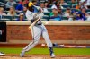 Milwaukee Brewers' Lorenzo Cain hits a single during the fourth inning of a baseball game against the New York Mets, Wednesday, June 15, 2022, in New York. (AP Photo/Frank Franklin II)