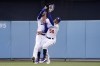 Los Angeles Dodgers right fielder Mookie Betts, right, collides with center fielder Cody Bellinger after making a catch on a ball hit by Los Angeles Angels' Taylor Ward during the first inning of a baseball game Wednesday, June 15, 2022, in Los Angeles. Betts lost control of the ball after the collision but Ward was thrown out at second by Bellinger. (AP Photo/Mark J. Terrill)