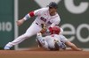 St. Louis Cardinals' Tyler O'Neill, bottom, slides out while attempting to steal second as Boston Red Sox's Trevor Story, top, prepares to tag him in the sixth inning of a baseball game, Sunday, June 19, 2022, in Boston. (AP Photo/Steven Senne)