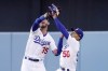 Los Angeles Dodgers right fielder Mookie Betts, right, collides with center fielder Cody Bellinger after making a catch on a ball hit by Los Angeles Angels' Taylor Ward during the first inning of a baseball game Wednesday, June 15, 2022, in Los Angeles. Betts lost control of the ball after the collision but Ward was thrown out at second by Bellinger. (AP Photo/Mark J. Terrill)