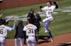 Pittsburgh Pirates' Jack Suwinski (65) leaps onto home plate after hitting a walkoff solo home run off San Francisco Giants relief pitcher Tyler Rogers during the ninth inning of a baseball game in Pittsburgh, Sunday, June 19, 2022. It was Suwinski's third solo home run of the game. (AP Photo/Gene J. Puskar)