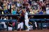 Arizona Diamondbacks' Buddy Kennedy (45) takes a curtain call after hitting a grand slam against the Minnesota Twins as Diamondbacks' Ketel Marte looks on during the sixth inning of a baseball game Sunday, June 19, 2022, in Phoenix. (AP Photo/Ross D. Franklin)