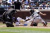 New York Mets' J.D. Davis scores ahead of the tag by Miami Marlins catcher Jacob Stallings during the fourth inning of a baseball game against the Miami Marlins, Monday, June 20, 2022, in New York. (AP Photo/Jessie Alcheh)