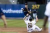 Seattle Mariners second baseman Adam Frazier (26) tags Oakland Athletics' Sheldon Neuse before throwing to first base for a double play during the second inning of a baseball game in Oakland, Calif., Tuesday, June 21, 2022. (AP Photo/John Hefti)