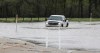 A truck drives through Red River flood water covering parts of  Hwy 220 south, May 30, 2022. (Ruth Bonneville / Winnipeg Free Press)