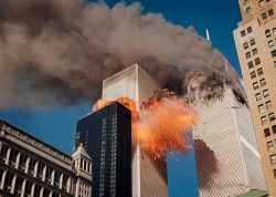 =
Smoke billows from one of the towers of the World Trade Center as flames and debris explode from the second tower, Tuesday, Sept. 11, 2001. (AP Photo/Chao Soi Cheong)