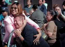 Two women hold each other as they watch the World Trade Center burn in New York Tuesday, Sept. 11, 2001. (AP Photo/Ernesto Mora)