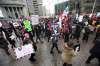 Thousands make their way through Portage and Main crossing on their way back down Portage Ave. to Portage Place during the Women's Day march, Saturday.