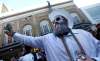 PHIL HOSSACK / WINNIPEG FREE PRESS -Fully equiped with mardi-gras beads and smart phone up, Jordan Banman brodcasts a live facebook video on Donald Street Friday evening. Stand-Up - April 13, 2018