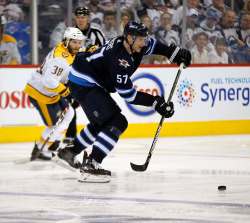 PHIL HOSSACK / Winnipeg Free Press - Winnipeg Jet #57 Tyler Myers oves the puck forward past Nashville Predator #38 Ryan Hartman in the second period of NHL game four playoff action in Winnipeg on Wednesday, May 3, 2018.