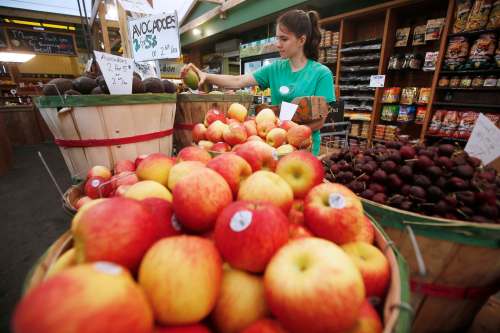 Emma Borger prepares some fruit baskets before the store opens. (John Woods / Winnipeg Free Press)