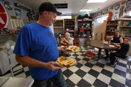 Owner Rick Wareham serves an order shortly after opening at 8 a.m.