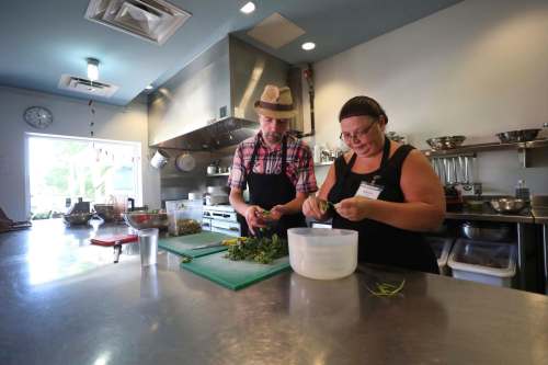 Head chef Grant Mitchell (left) and volunteer chef Marsha Barber prepare lunch.