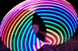 Hoopist Karrie Blackburn shows off her skills with a lit up hula-hoop at the Zoo Lights Festival. (Daniel Crump / Winnipeg Free Press)