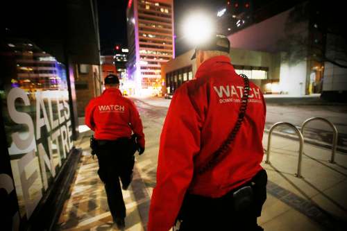 Downtown Watch ambassador Joel Hildebrand (left) and supervisor Perry Squires walk the streets of downtown. (John Woods / Winnipeg Free Press)