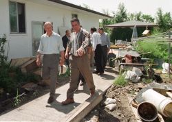 On June 28, 1997, His Royal Highness Prince Philip (left), The Duke of Edinburgh, surveys damage in the backyard of the home of Elie and Anne Dorge with Liberal MP for Provencher, David Iftody, in Ste. Agathe, Man. The Prince was on a quick a tour of the town that was damaged by flooding of the Red River on April 27. (Reuters files)