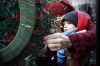 John Woods / The Canadian Press
A mother and child place a poppy on a wreath during a Remembrance Day service in Winnipeg, Tuesday, November 11, 2014.