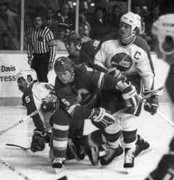 Hawerchuk and Paul MacLean battle against their bitter rivals, the Calgary Flames, on Oct. 24, 1986. (Wayne Glowacki / Winnipeg Free Press files)