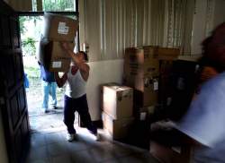 A delivery man juggles a stack of boxes as the Op-Walk