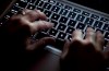 A woman uses a computer keyboard in North Vancouver, B.C., on December 19, 2012. Canada's cyberspy agency launched a defensive operation to protect last year's federal election — including the party leaders's debate — from disruption by foreign agencies, its annual report published today says.THE CANADIAN PRESS/Jonathan Hayward