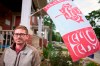 Blaine Chalk poses for a photo in front of his home in London, Ont., where he flies a version of the Canadian Flag designed by Indigenous artist Curtis Wilson, Monday, June 27, 2022. THE CANADIAN PRESS/Geoff Robins