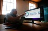 Shaun Vincent, creative director of Vincent Design, looks at the papal visit logo in his design studio in Winnipeg, Monday, June 27, 2022. Vincent has designed the logo and branding materials for the upcoming papal visit. THE CANADIAN PRESS/John Woods