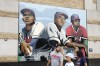 Fans walk past the mural 