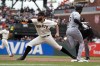 Chicago White Sox's Tim Anderson (7) beats out an infield single as San Francisco Giants first baseman Brandon Belt (9) takes the late relay during the fourth inning of a baseball game, Saturday, July 2, 2022, in San Francisco. (AP Photo/D. Ross Cameron)