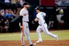 Arizona Diamondbacks' Daulton Varsho (12) celebrates his three-run home run as he runs past San Francisco Giants third baseman Evan Longoria during the eighth inning of a baseball game Tuesday, July 5, 2022, in Phoenix. (AP Photo/Ross D. Franklin)