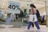 Shoppers walk past a shop on November 26, 2021. THE CANADIAN PRESS/Paul Chiasson