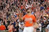 Fans wearing promotional Hawaiian shirts react after the Baltimore Orioles recorded the final out against the Los Angeles Angels during the ninth inning of a baseball game, Saturday, July 9, 2022, in Baltimore. The Orioles won 1-0. (AP Photo/Julio Cortez)