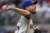 New York Mets starting pitcher Max Scherzer works against the Atlanta Braves in the third inning of a baseball game, Monday, July 11, 2022, in Atlanta. (AP Photo/John Bazemore)