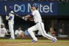 Texas Rangers' Corey Seager watches his solo home run during the ninth inning of the team's baseball game against the Oakland Athletics, Tuesday, July 12, 2022, in Arlington, Texas. (AP Photo/Tony Gutierrez)