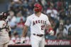 Los Angeles Angels' Mike Trout walks toward the dugout after striking out against the Houston Astros during the first inning of a baseball game Tuesday, July 12, 2022, in Anaheim, Calif. (AP Photo/Jae C. Hong)