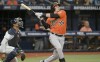 Tampa Bay Rays catcher Christian Bethancourt, left, looks on as Baltimore Orioles pinch hitter Adley Rutschman hits a solo home run to right field during the eighth inning of a baseball game Saturday, July 16, 2022, in St. Petersburg, Fla. (AP Photo/Steve Nesius)