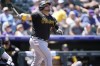Pittsburgh Pirates' Daniel Vogelbach follows the flight of his RBI-single off Colorado Rockies starting pitcher Austin Gomber in the first inning of a baseball game, Sunday, July 17, 2022, in Denver. (AP Photo/David Zalubowski)