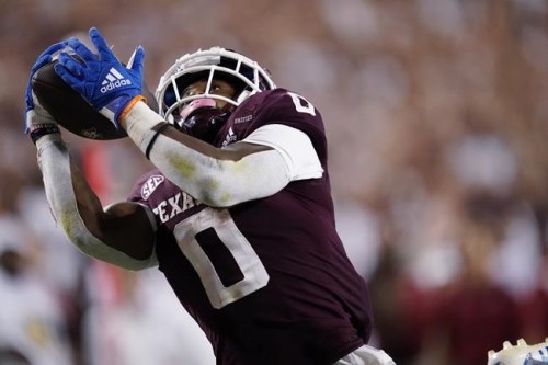 FILE - Texas A&M wide receiver Ainias Smith catches a 25-yard touchdown pass against Alabama during the fourth quarter of an NCAA college football game Saturday, Oct. 9, 2021, in College Station, Texas. Texas A&M receiver Ainias Smith was arrested early Wednesday, July 20, 2022, on charges of driving while intoxicated, unlawful carrying of a weapon and possession of less than 2 ounces of marijuana, according to Brazos County jail records. Smith, 21, was arrested by Texas A&M police and was booked into the Brazos County jail. (AP Photo/Sam Craft, File)