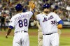 New York Mets Daniel Vogelbach high fives acting first base coach Raphael Fernandez after singling on a line drive during the fifth inning of a baseball game against the San Diego Padres, Sunday, July 24, 2022, in New York. (AP Photo/Julia Nikhinson)