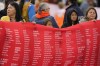 Indigenous people hold up a banner while waiting for Pope Francis during his visit to Maskwaci, the former Ermineskin Residential School, Monday, July 25, 2022, in Maskwacis, Alberta. Pope Francis traveled to Canada to apologize to Indigenous peoples for the abuses committed by Catholic missionaries in the country's notorious residential schools. (AP Photo/Eric Gay)