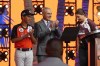 MLB Commissioner Rob Manfred, center, claps for Willa Suarez, right, standing next to Ryan Zamora, left, of Uvalde, Tex., during the 2022 MLB baseball draft, Sunday, July 17, 2022, in Los Angeles. Suarez and Zamora announced the Houston Astros first round pick. (AP Photo/Abbie Parr)